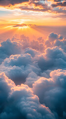 Aufkleber - An aerial view of dramatic clouds at sunset with rays of golden light breaking through, symbolizing beauty, peace, and the vastness of nature.
