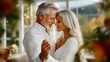 © Yuliia - Romantic mature couple dancing together, silver-haired man and blonde woman in white clothing share intimate moment with soft natural lighting and bokeh background.