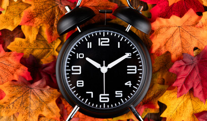 Wall Mural - Classic desktop alarm clock and  autumn leaves