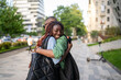 © DimaBerlin - Smiling black wife laugh and hug husband tightly, emotional family reunion outdoors. Joy and love of reconnecting after separation, happiness. Spouse or relative return home after time apart