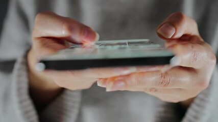 Woman scrolling through social media feeds on smartphone close up