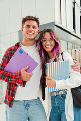 Fototapete - Vertical. Joyful students sharing a moment of friendship and laughter in a university campus , showcasing the essence of youth, education, and camaraderie between high school classmates