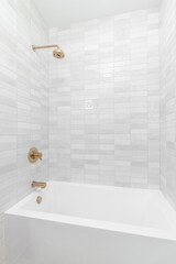 Wall Mural - A marble tiled shower with a large white bathtub and gold shower head.