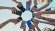 © Довидович Михаил - Group of friends is making circle with mobile phones holding smartphones in hands standing together on blue sky background.