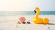 © dreamdes - Inflatable yellow flamingo float on tropical beach with seashells and sunglasses. Summer vacation concept. Ocean scenery with sandy shore and copy space