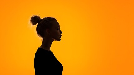 Poster - Stunning silhouette portrait with dramatic rim lighting creating a bold minimalist and captivating visual against a vibrant orange background