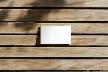 Poster - Clean Minimalist Mockup Featuring a White Card on a Wooden Surface with Tree Shadow for Branding and Design Presentation, Ideal for Modern Aesthetic Concepts