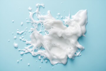 Wall Mural - White foamy splash sits atop a pale blue background