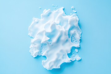 Canvas Print - White foamy substance with bubbles on a solid light blue background