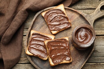 Wall Mural - Tasty sandwiches with chocolate butter on wooden table, top view