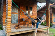 © Allison - Relaxing on the porch with dogs at a wooden cabin in nature