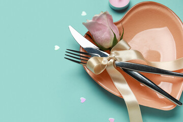 Wall Mural - Table setting for Valentine's Day with pink rose and hearts on blue background