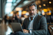 © MastersedZ - Businessman Working on Laptop at Airport Terminal During Travel