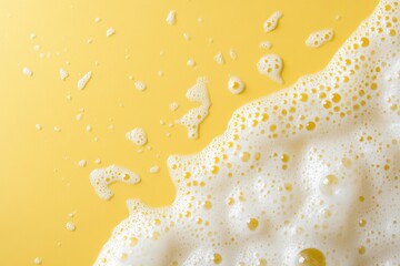 Wall Mural - Close up of white foam bubbles on yellow background