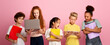 © Prostock-studio - Portrait of multiethnic schoolchildren with notebooks using tablet and laptop to study over pink background