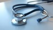 © Ummeya - Close up of a Medical Stethoscope on a White Surface Healthcare Symbol