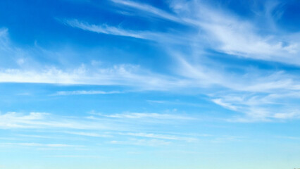 Wall Mural - blue sky with wispy clouds the image features a clear blue sky adorned with wispy, delicate clouds. 