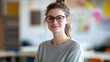 © Daiki - Portrait of a young female teacher smiling in a classroom setting, showcasing a positive and engaging atmosphere ideal for education and mentorship.