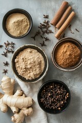 Wall Mural - Assorted spices and ginger on a rustic surface with cloves and cinnamon sticks