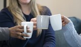 Three coffee cups, three women having coffee at home, white and grey cups