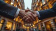 © Aekkapon - Businessmen shaking hands city street background partnership deal agreement success