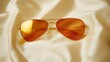 © Windi - Amber aviator sunglasses on silk, sun reflection, fashion shoot
