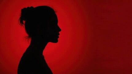 Wall Mural - Woman Silhouette Against Red Background