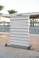Poster - modern architectural installation with geometric design near a beach during sunset hours