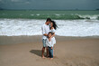 © alexkoral - happy family with a child boy on the beach by the sea in summer