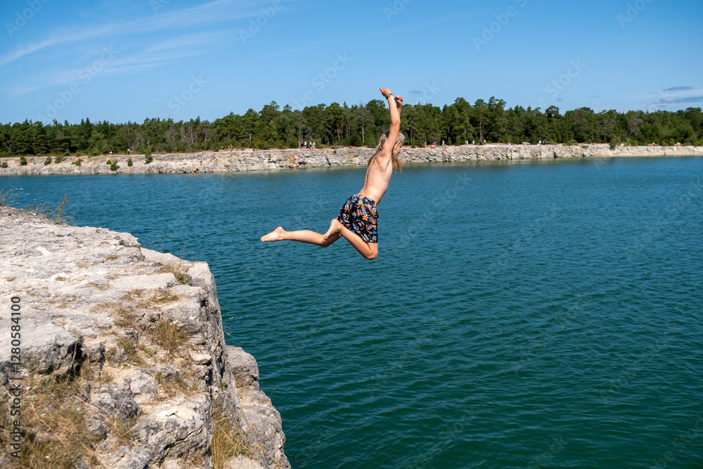 Shirtless boy diving with arms raised in lake Stock Photo | Adobe Stock