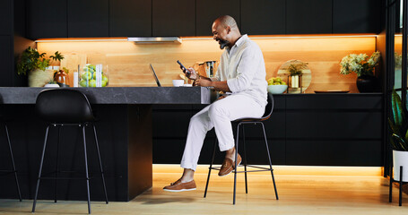 Aufkleber - Remote work, phone and black man in kitchen with laptop for research, online networking and website. Professional, home and person with smartphone for finance consulting, insurance and planning
