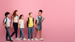 © Prostock-studio - Body size portrait of schoolkids walking to school hand in hand on pink background