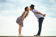 © Voyagerix - Couple flirting kissing on date against sky background