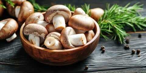 Poster - Fresh organic mushrooms in a wooden bowl on dark textured wood, surrounded by pine branches and scattered peppercorns showcasing earthy tones.