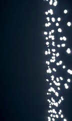 Poster - Mesmerizing vertical cascade of glowing particles against dark background