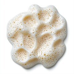 Close-up of white sponge with gold dots and rich creamy cleanser foam texture on surface