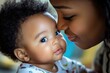 © Yevhen - Joyful Bonding: African American Mother Engaging in Love Sign Language with Her Baby Boy