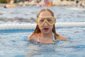 Young child girl having fun in summer water