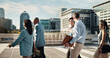 © PeakPoints/peopleimages.com - Teamwork, walking and business people in city in discussion on morning commute, travel and journey. Corporate, professional and men and women in town talking for collaboration, meeting and career