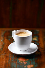 Wall Mural - Cup of coffee on wooden background. Soft focus. Copy space