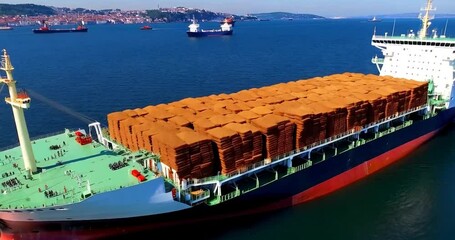 Poster - Cargo Ship loaded with logs and other goods, sailing the calm sea with other boats
