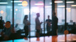 © Perecciv - Group of people silhouettes against large window, businessmen participating in meeting or discussion.