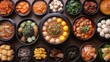© Hnf - Overhead shot of various Korean dishes in small bowls on a wooden table.