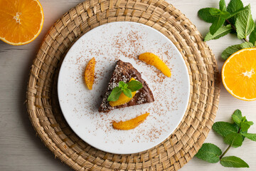 Wall Mural - Delicious piece of chocolate cake with fresh orange pieces.