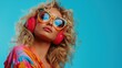 © Mariia - Closeup of blonde woman with curly hair, wearing colorful and large sunglasses with red headphones on her head against blue background with copy space. 80s style fashion concept. Retro theme.