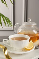 Wall Mural - Refreshing green tea and slice of lemon on tray, closeup