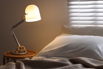 Wall Mural - Glowing night lamp on bedside table indoors