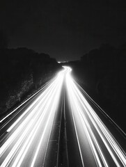 Poster - Monochrome highway at night with light trails from passing vehicles creating a dynamic and dramatic scene