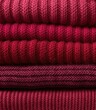 © Natalia - Stack of cozy burgundy sweaters