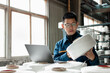© zhu difeng - Middle-aged Chinese men are using laptops in a textile factory.